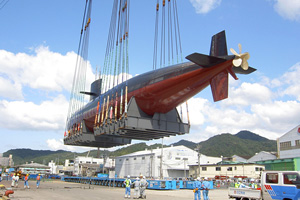 The submarine being lifted by a floating crane