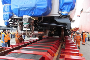 Loading railway carriages onto the special trailer with its built-in railway tracks