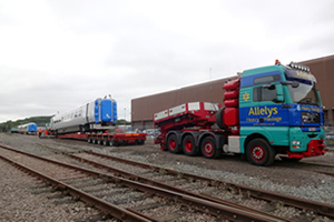 Loading railway carriages onto the special trailer with its built-in railway tracks